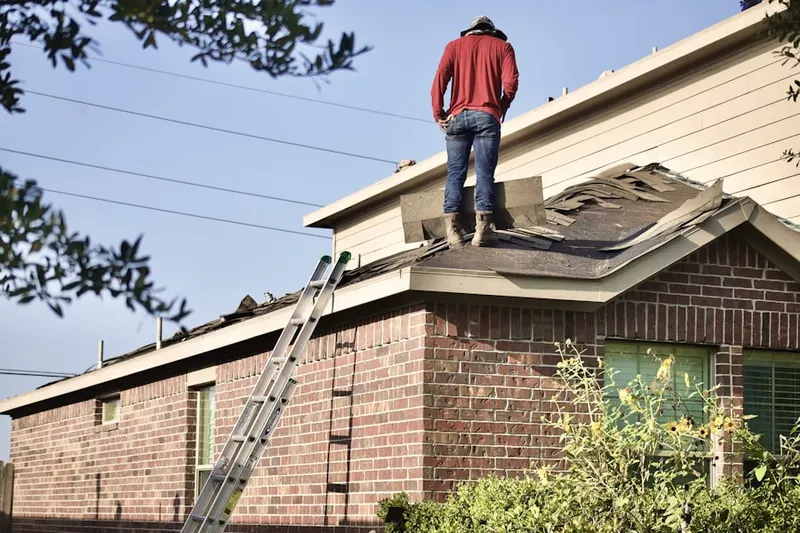 Professional roofer working on a residential roof in Tall Timbers